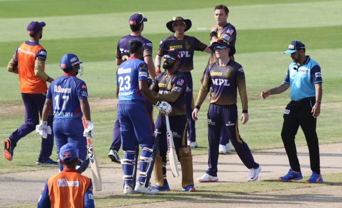 Dinesh Karthik intervenes as Delhi Capitals batter Ravichandran Ashwin gets into an argument with Kolkata Knight Riders pacer Tim Southee during the IPL match in Sharjah on Tuesday, September 28