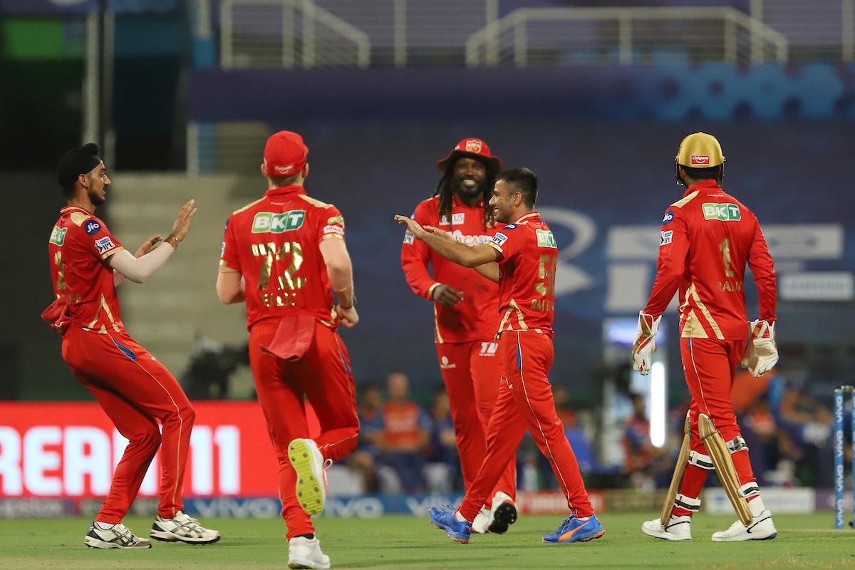 Punjab Kings spinner Ravi Bishnoi celebrates with teammates after dismissing Mumbai Indians captain Rohit Sharma.