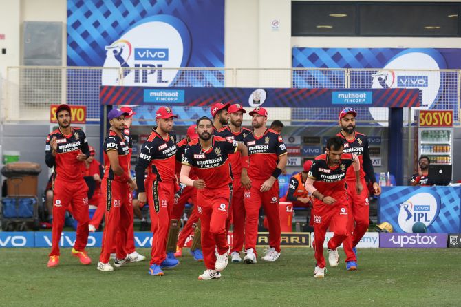 Royal Challengers Bangalore players take the field after putting Rajasthan Royals in to bat in the Indian Premier League match, in Dubai, on Wednesday. 