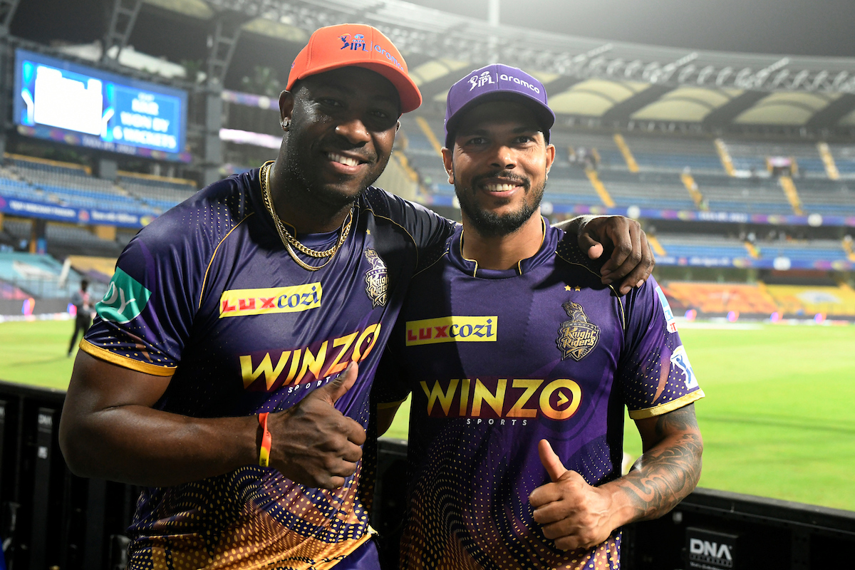 Andre Russell and Umesh Yadav pose with the Orange and Purple caps after steering Kolkata Knight Riders to an easy victory over Punjab Kings in the Indian Premier League match,  at the Wankhede stadium in Mumbai, on Friday.