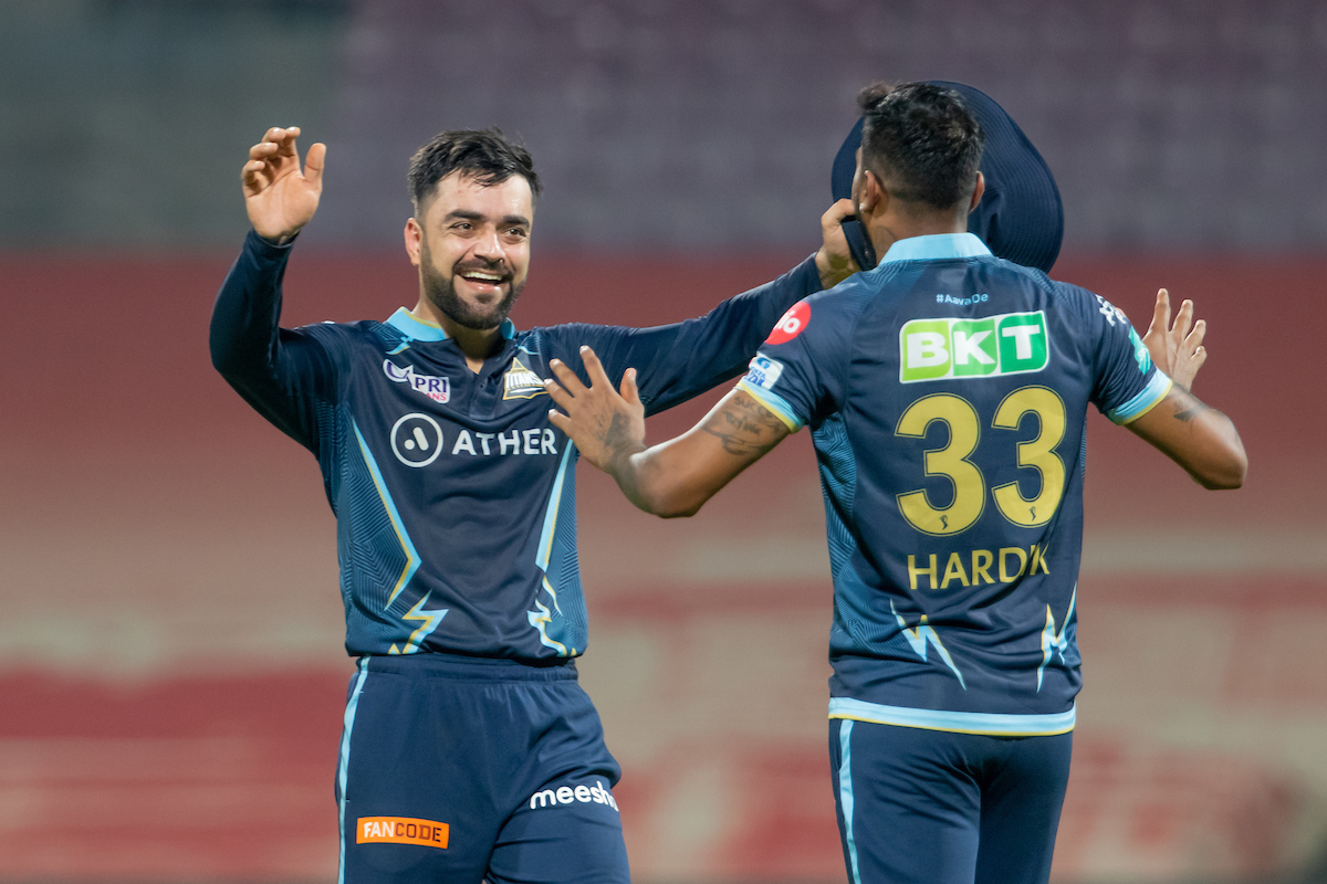 Rashid Khan celebrates with skipper Hardik Pandya after Gujarat Titans pull off a dramatic eight-run victory over Kolkata Knight Riders in the IPL match, at the DY Patil Stadium in Navi Mumbai, on Saturday.