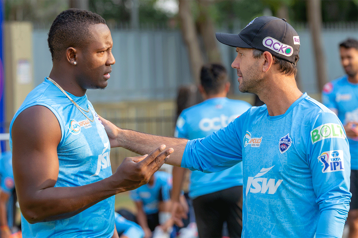 DC's Rovman Powell speaks to coach Ricky Ponting during a training session