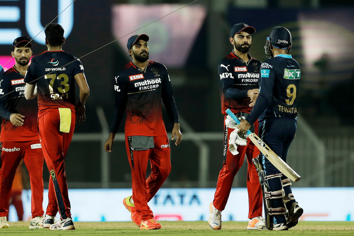 Gujarat Titans's Rahul Tewatia is congratulated by Royal Challengers Bangalore after the match on Saturday