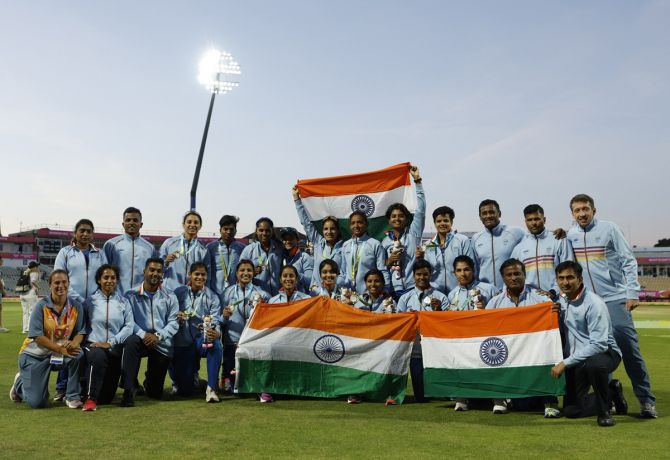 India's players celebrate with the Tricolour and their silver medals after the women's T20 cricket medal ceremony at the Commonwealth Games on Sunday.
