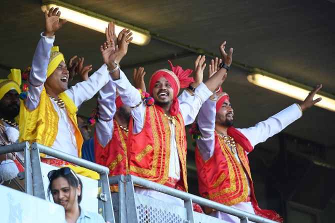 Indian fans at the packed Edgbaston Cricket Ground celebrate a boundary.