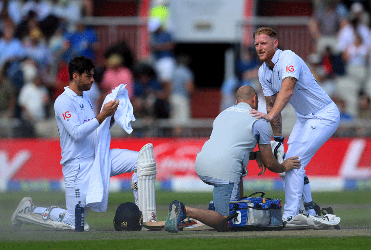 England's Ben Stokes tweaks his left knee as the physio checks on him