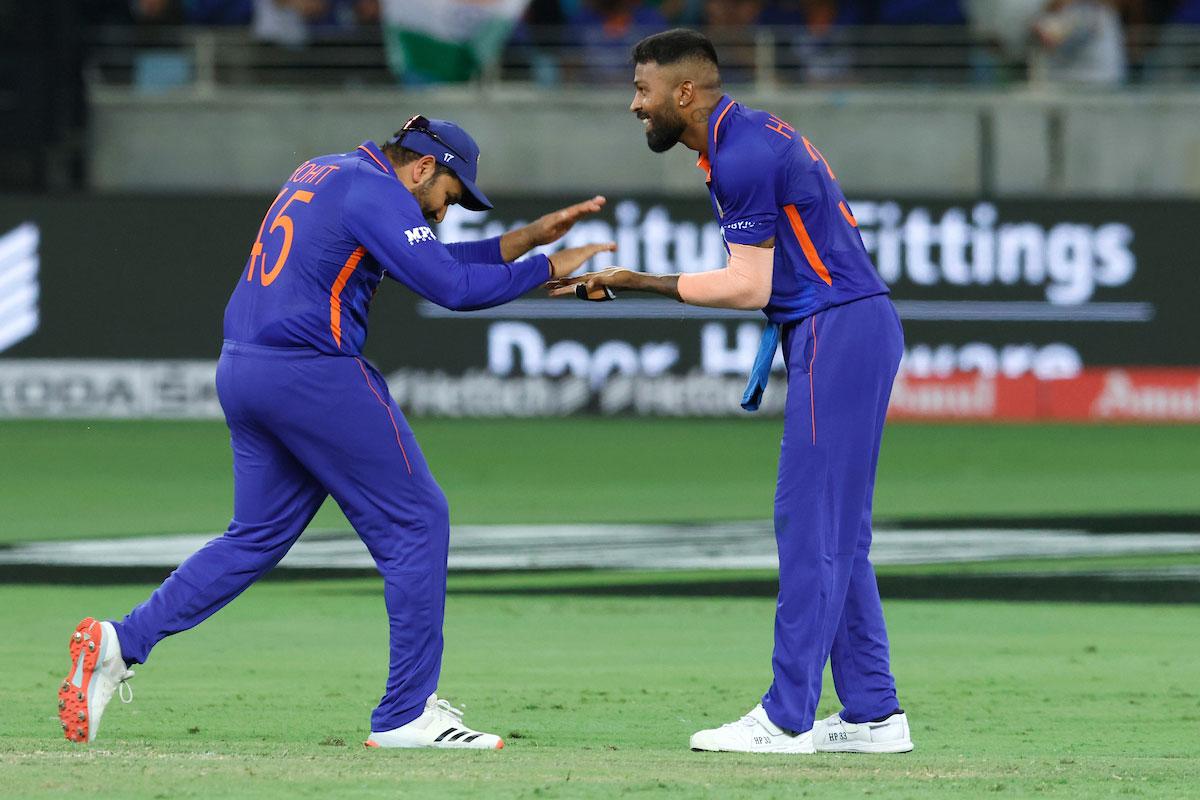 Hardik Pandya celebrates with captain Rohit Sharma after taking the wicket of Khushdil Shah