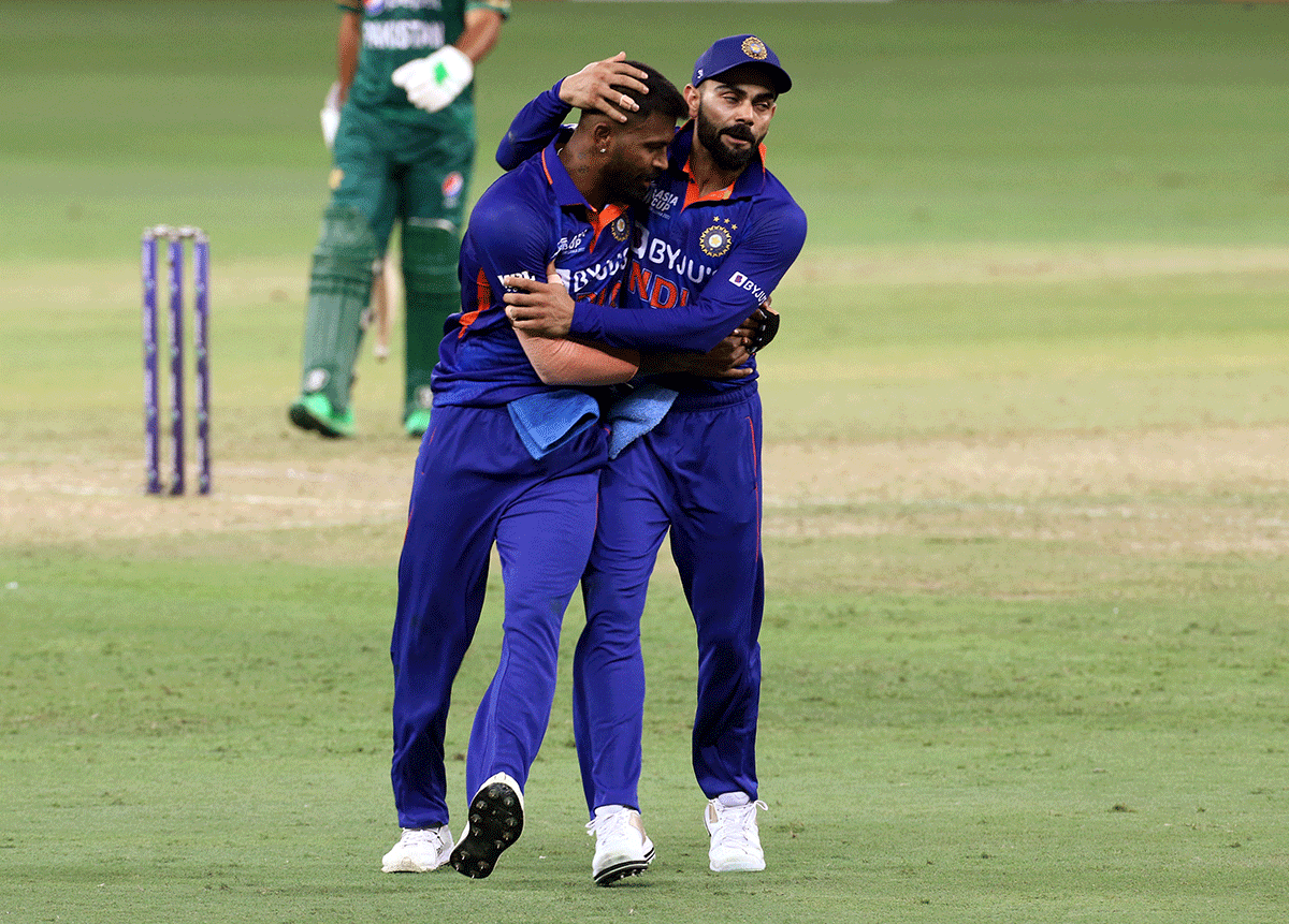India's Hardik Pandya celebrates with Virat Kohli after taking the wicket of Pakistan's Mohammad Rizwan