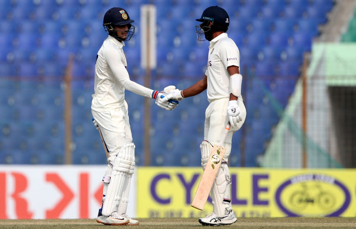 Shubman Gill and Cheteshwar Pujara celebrates their 50-run stand.