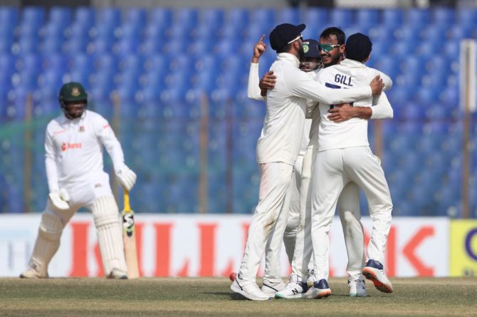 Axar Patel celebrates with his India teammates after taking the wicket of Yasir Ali. 