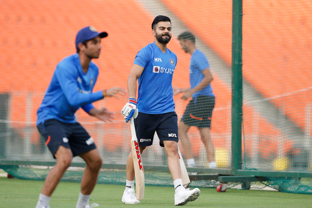 Virat Kohli walks in to bat at the nets