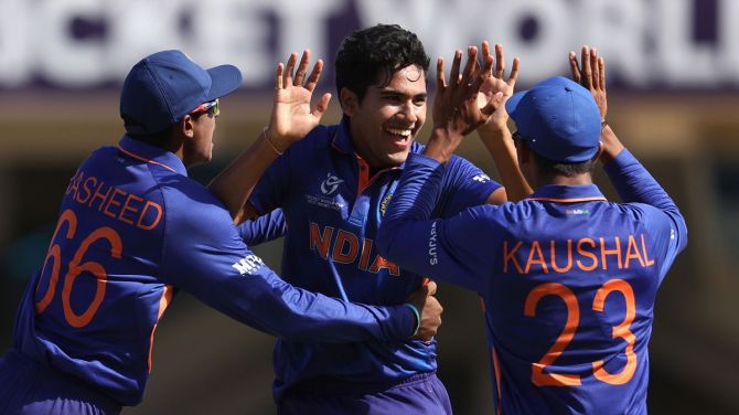 India's Raj Bawa celebrates with teammates Shaik Rasheed and Kaushal Tambe after dismissing England's George Bell during the ICC Under-19 men's World Cup final, at Sir Vivian Richards Stadium in Antigua, on Saturday.