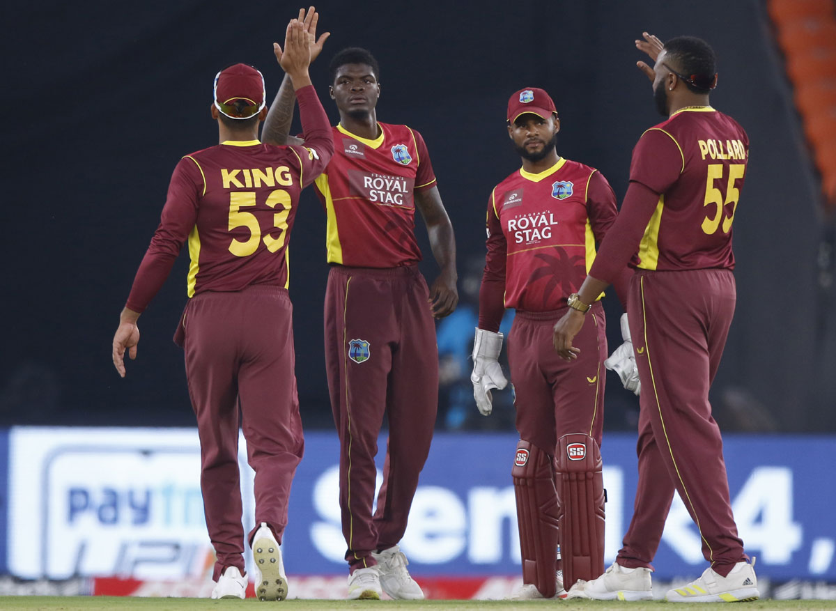 West Indies pacer Alzarri Joseph celebrates the wicket of Rohit Sharma.