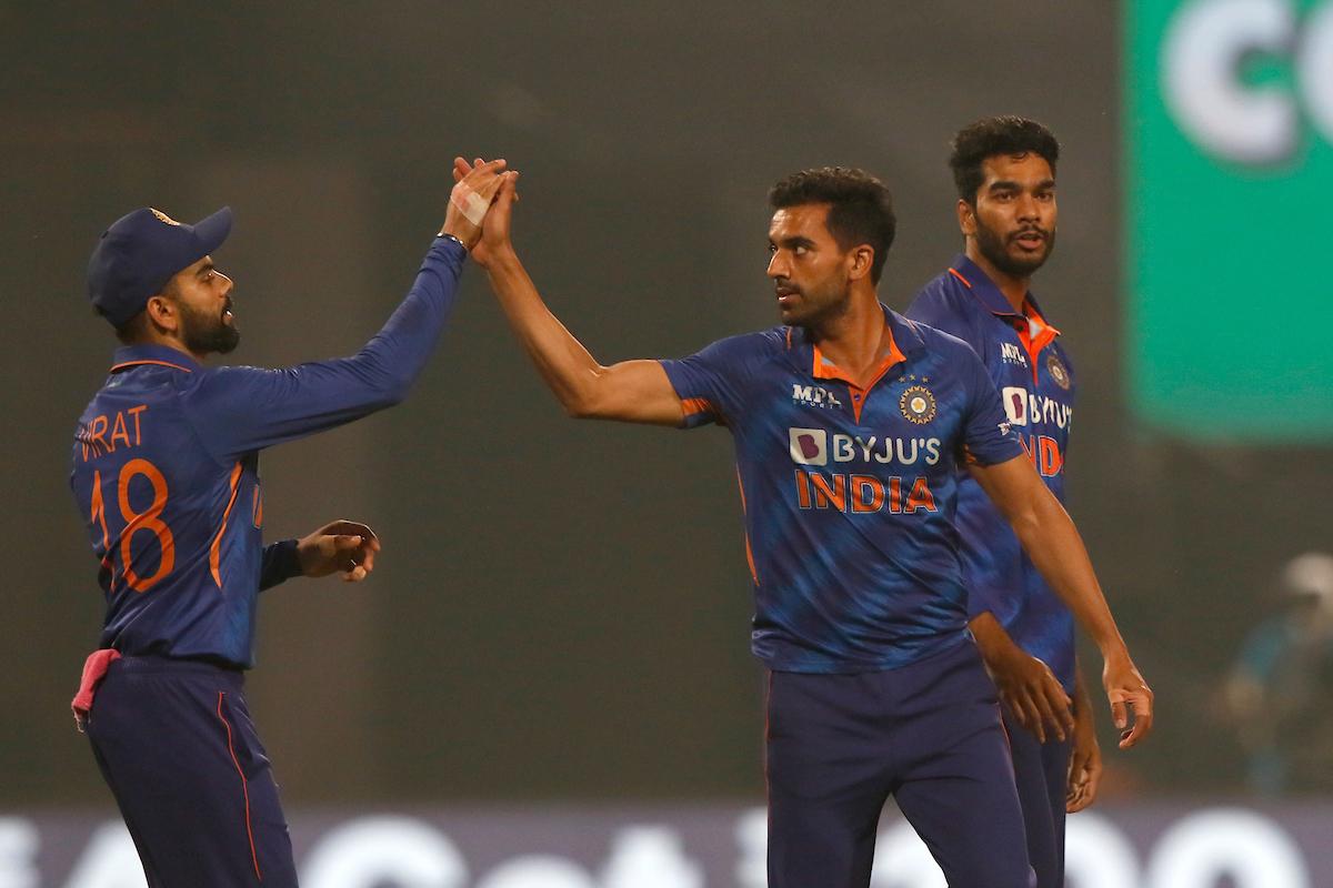 Venkatesh Iyer watches as India pacer Deepak Chahar celebrates the wicket of Nicholas Pooran with Virat Kohli during the first T20I against the West Indies at the Eden Gardens in Kolkata on Wednesday.