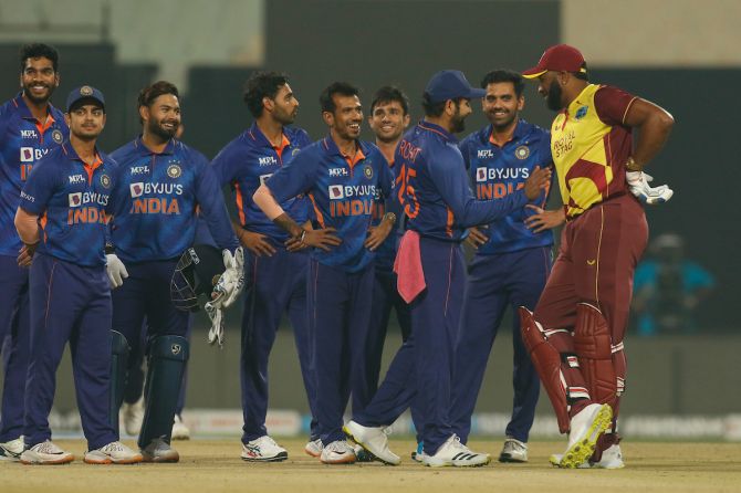 Captain Rohit Sharma and his India teammates share a light moment with West Indies captain Kieron Pollard as they await a decision review during the first T20 International, at the Eden Gardens in Kolkata, on Wednesday.