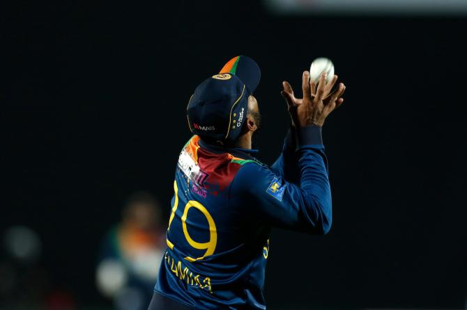 Chamika Karunaratne takes the catch to dismiss Rohit Sharma.