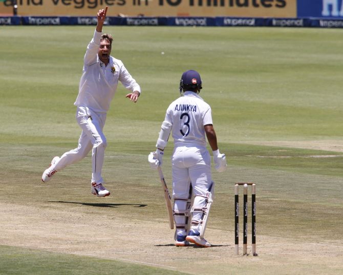 Duanne Olivier celebrates after taking the wicket of India's Ajinkya Rahane