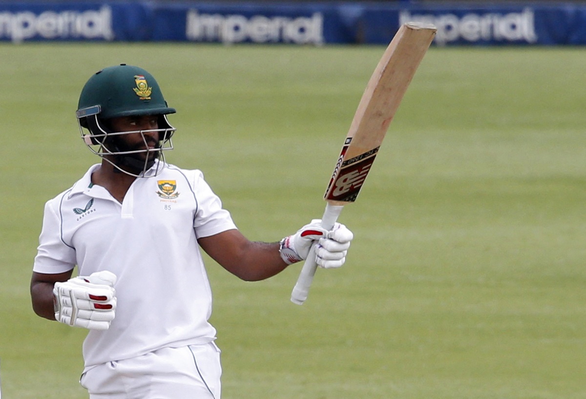 Temba Bavuma waves to the South Africa dressing room after completing a half-century.