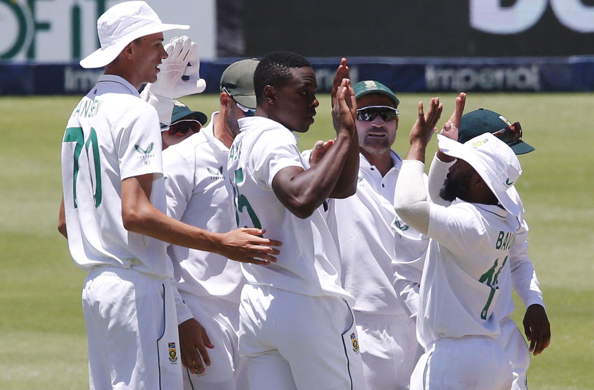 Kagiso Rabada rejoices with his South Africa teammates after taking the wicket of Rishabh Pant.