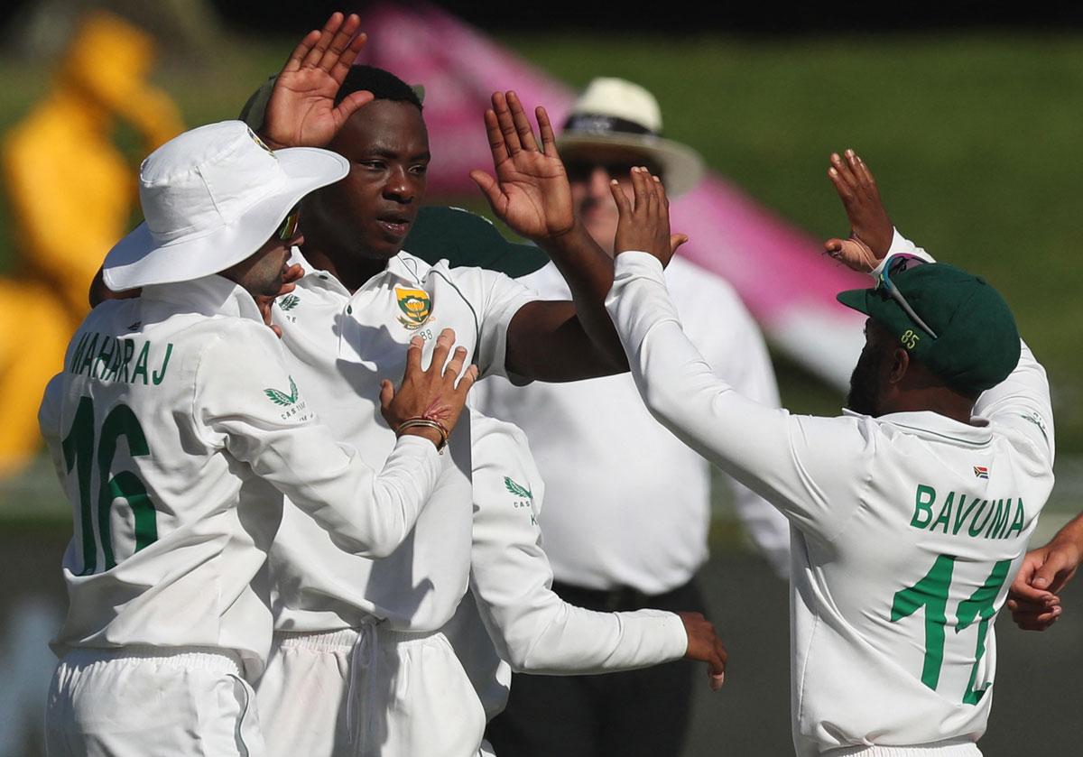 South Africa pacer Kagiso Rabada celebrates with teammates after dismissing Virat Kohli.