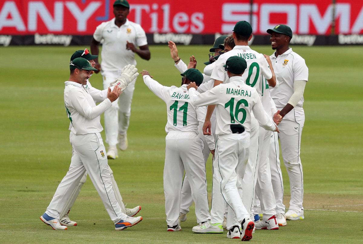 South Africa's Duanne Olivier celebrates with teammates after taking the wicket of India opener K L Rahul.