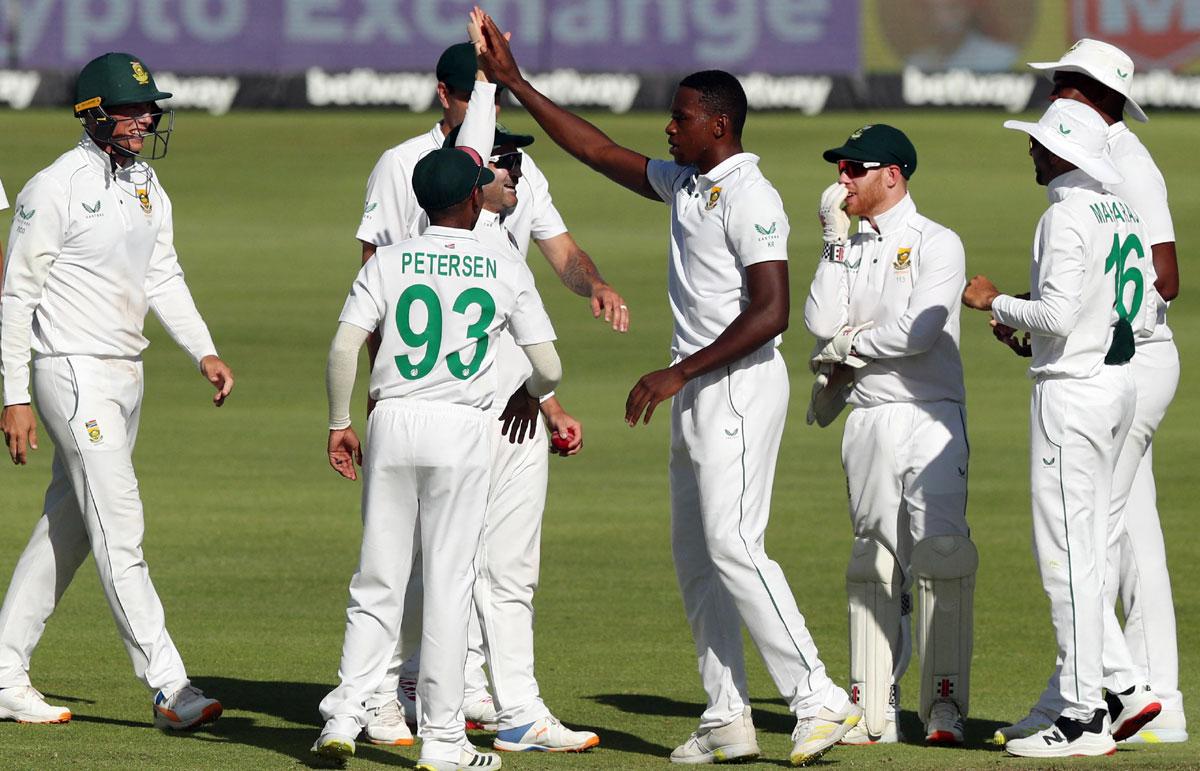 Kagiso Rabada celebrates with teammates after taking the wicket of India opener Mayank Agarwal.