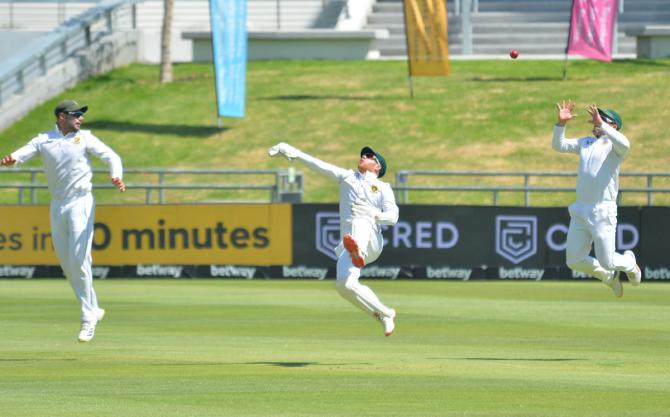 Dean Elgar, right, takes the catch to dismiss Ajinkya Rahane.