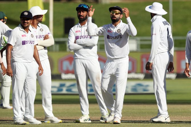 Virat Kohli and his teammates react after losing a leg before wicket review against Dean Elgar.