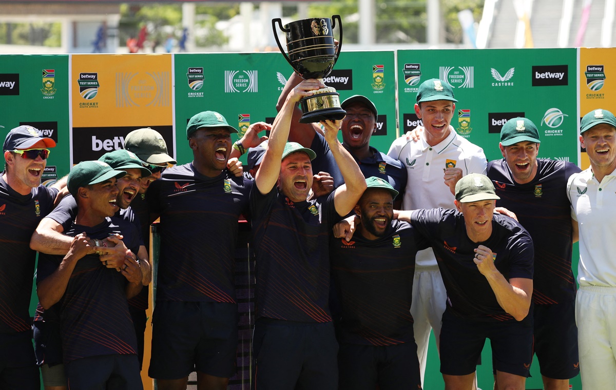 South Africa skipper Dean Elgar celebrates with teammates and the trophy after winning the third Test and series against India  at Newlands Cricket Ground, Cape Town, on Friday.