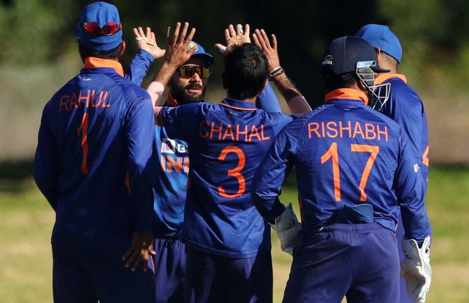 Yuzvendra Chahal celebrates with teammates after taking the wicket of Temba Bavuma.