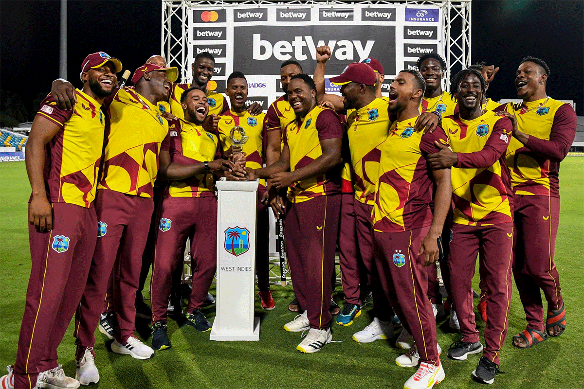 West Indies players celebrate with the trophy after beating England to win the T20 series. 