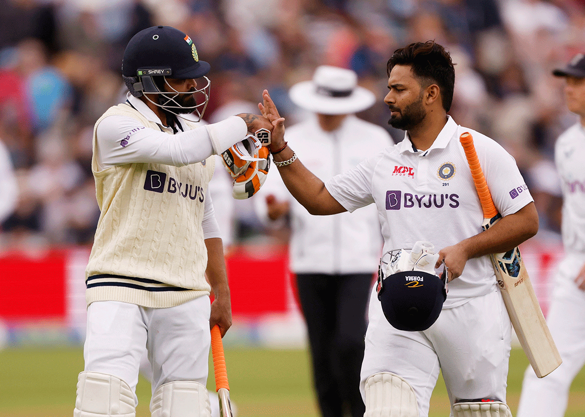 India's Rishabh Pant and Ravindra Jadeja walk off for the field at tea