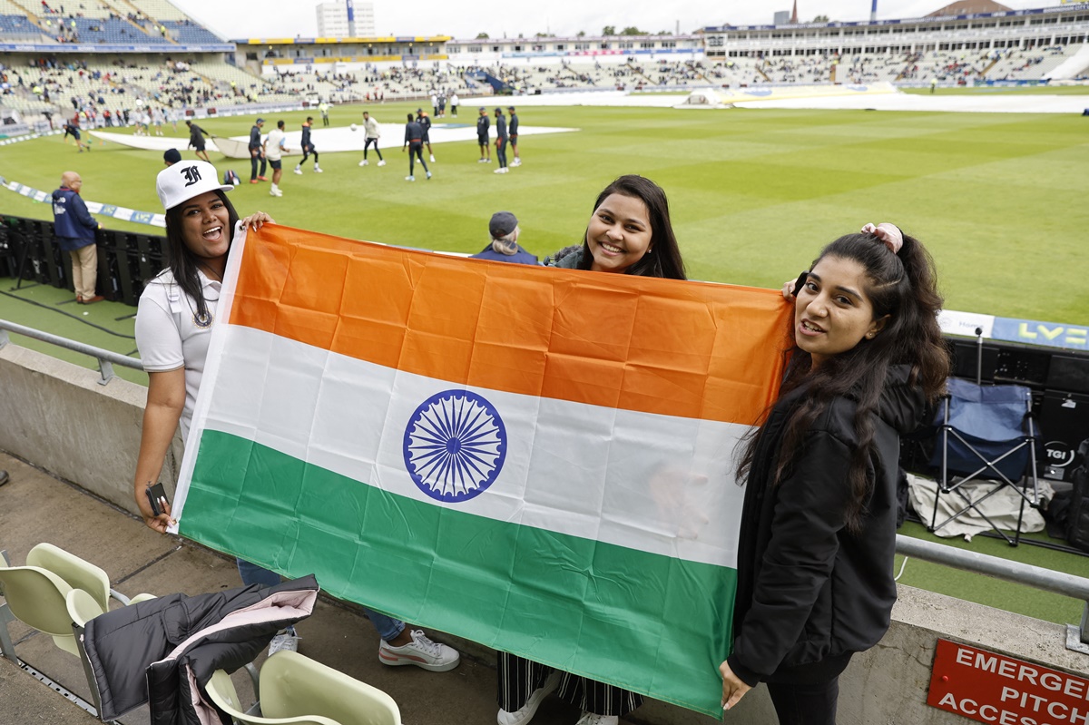 Indian fans pose for a picture with the national flag before play commences on Day 2 of the rescheduled fifth Test between England and India at Edgbaston, Birmingham, on Saturday.