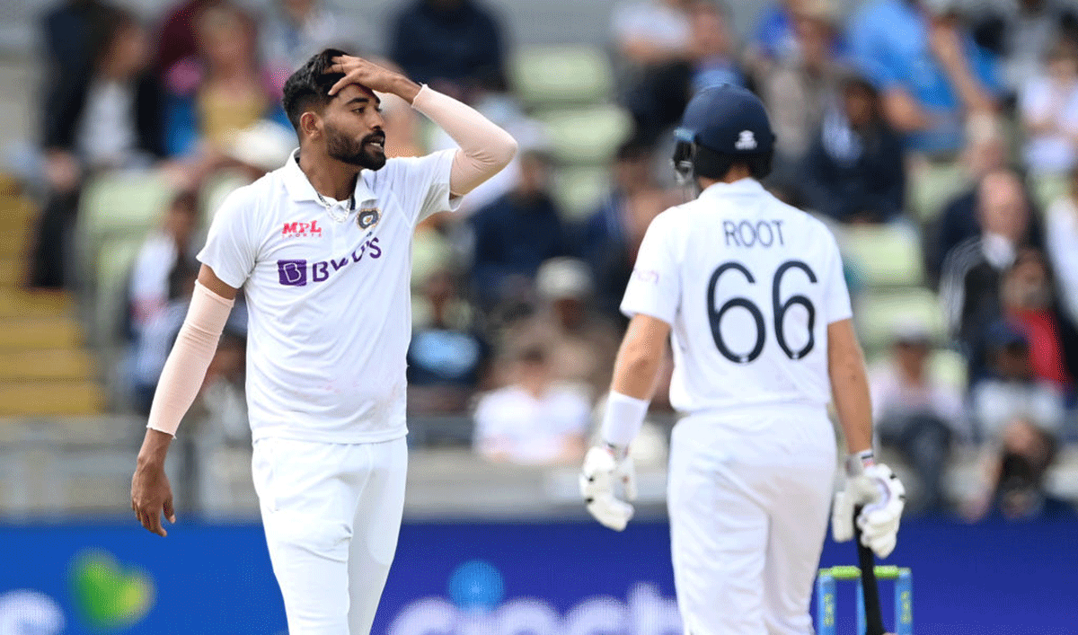 India's Mohammed Siraj reacts after being hit for a boundary by Joe Root