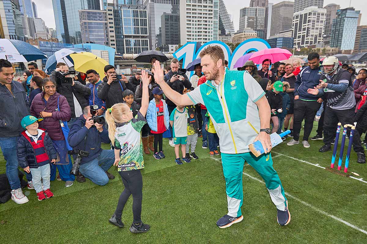 Aaron Finch high fives a young fan during a game of cricket at the T20 World Cup Trophy Tour Launch  