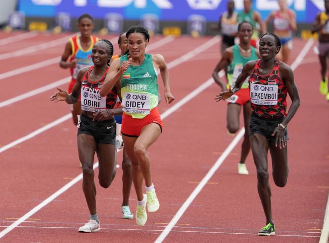 Letesenbet Gidey crosses the line ahead of Kenya's Hellen Obiri and Margaret Chemlimo Kpikemboi in the women's 10,000m final.