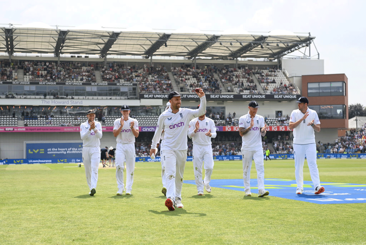 England's Jack Leach holds up the ball after taking five wickets