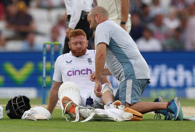 Jonny Bairstow receives medical attention after sustaining an injury.