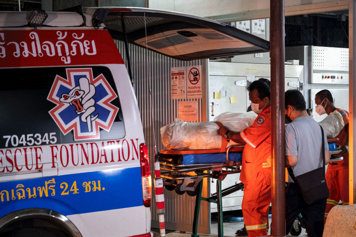Health workers load the body of Shane Warne onto an ambulance for departure from the morgue at Suratthani Hospital to Bangkok in Surat Thani, Thailand, on Monday, before returning to Australia.