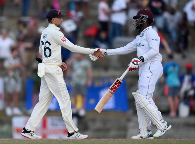West Indies batter Nkrumah Bonner shakes hands with England captain Joe Root after the drawn first Test, at Sir Vivian Richards Stadium in Antigua, on Saturday.