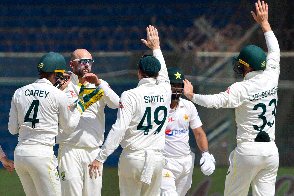 Nathan Lyon celebrates with teammates on dismissing Babar Azam