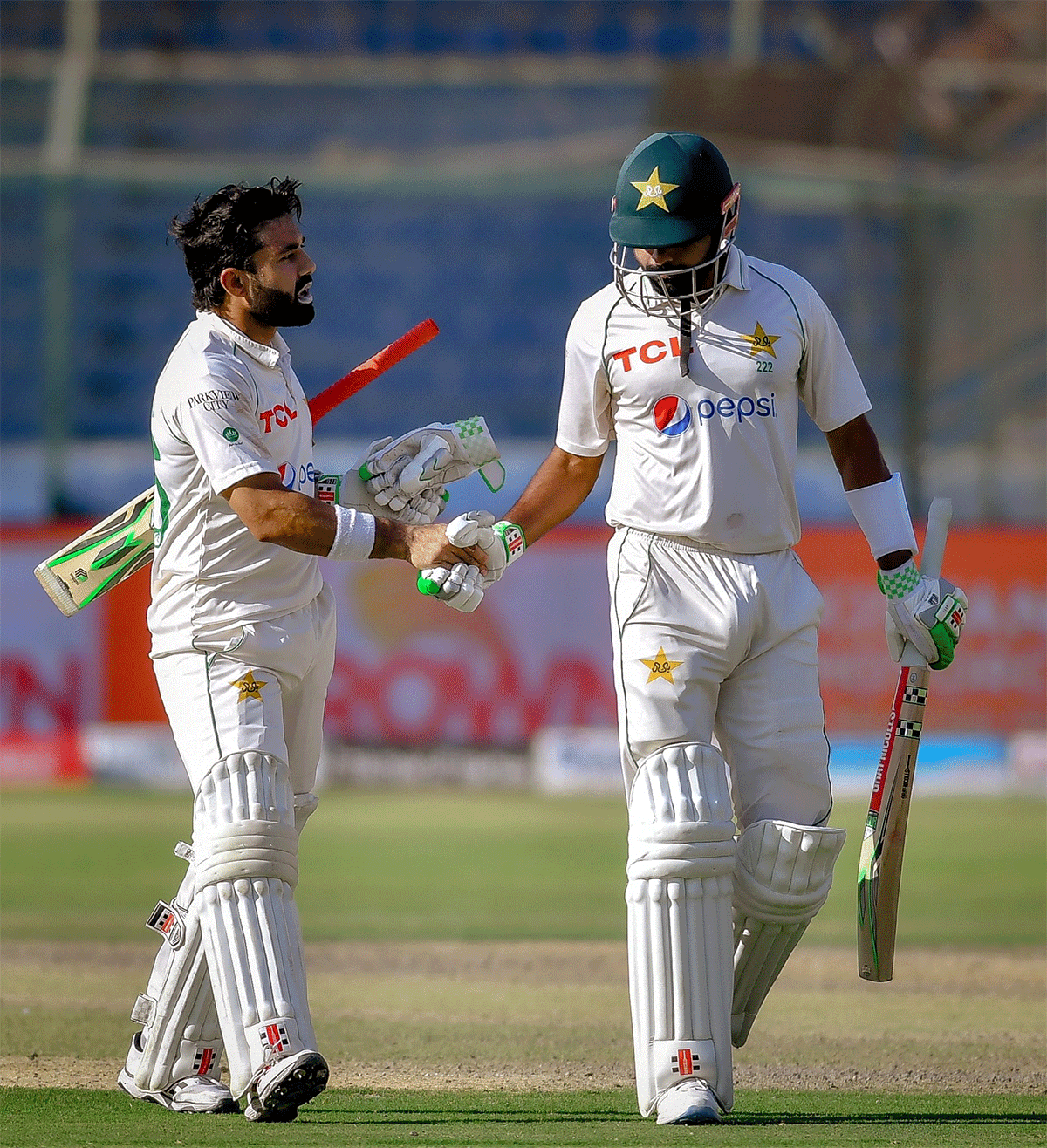 Mohammad Rizwan, who scored an unbeaten 104, congratulates Babar Azam on completing his 150 on Day 5 of the 2nd Test in Karachi on Wednesday
