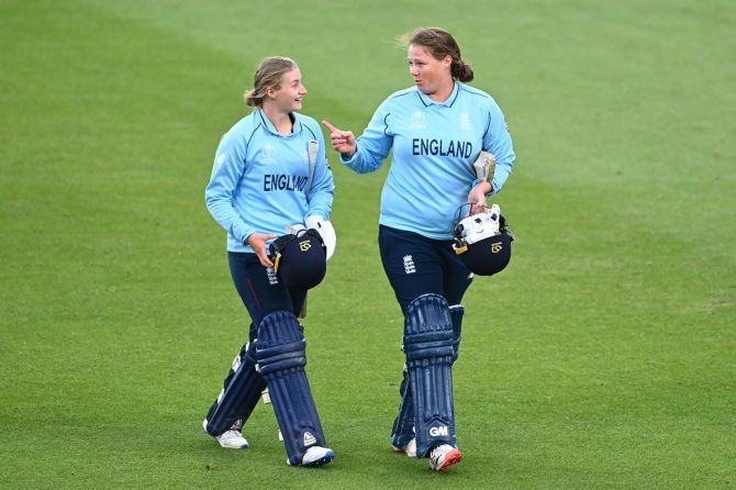 England's Anya Shrubsole, right, and Charlie Dean celebrate victory over New Zealand in the Women's Cricket World Cup match, at Eden Park in Auckland, New Zealand, on Sunday.