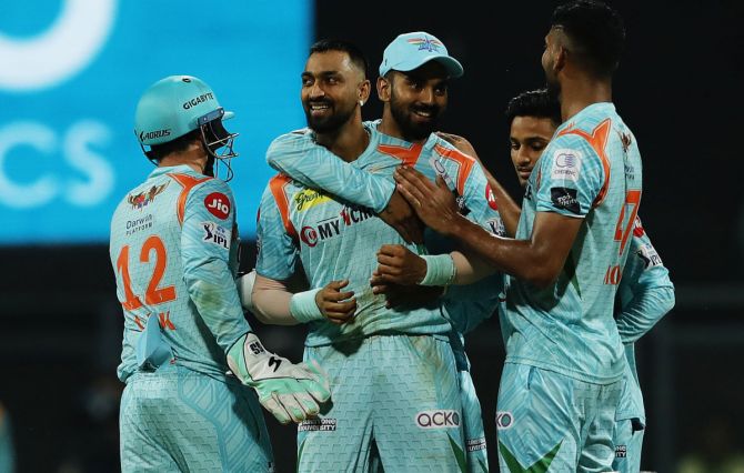 Krunal Pandya celebrates with team-mates after taking the wicket of his brother 