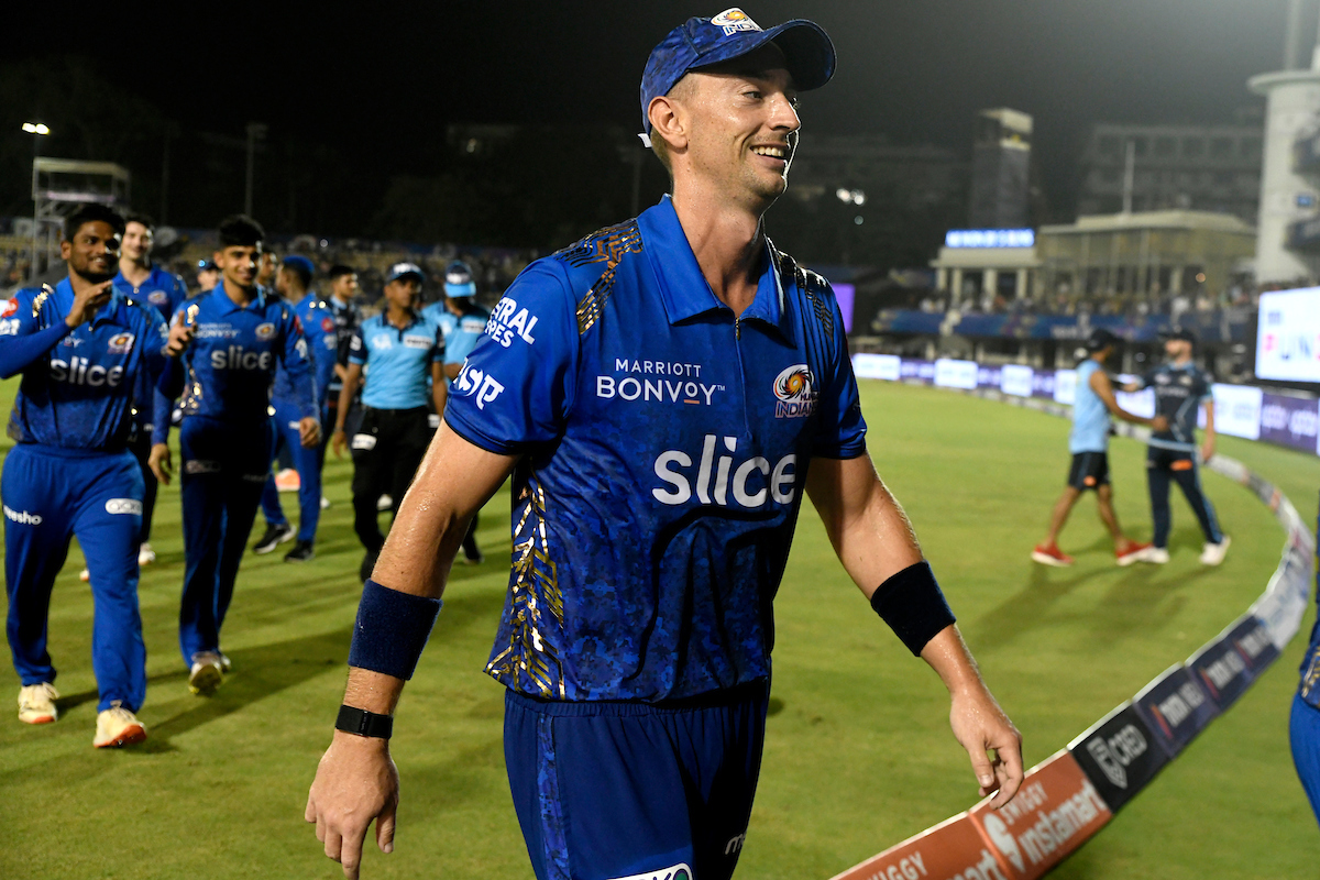 Daniel Sams leads Mumbai Indians off the field after his match-winning last over.