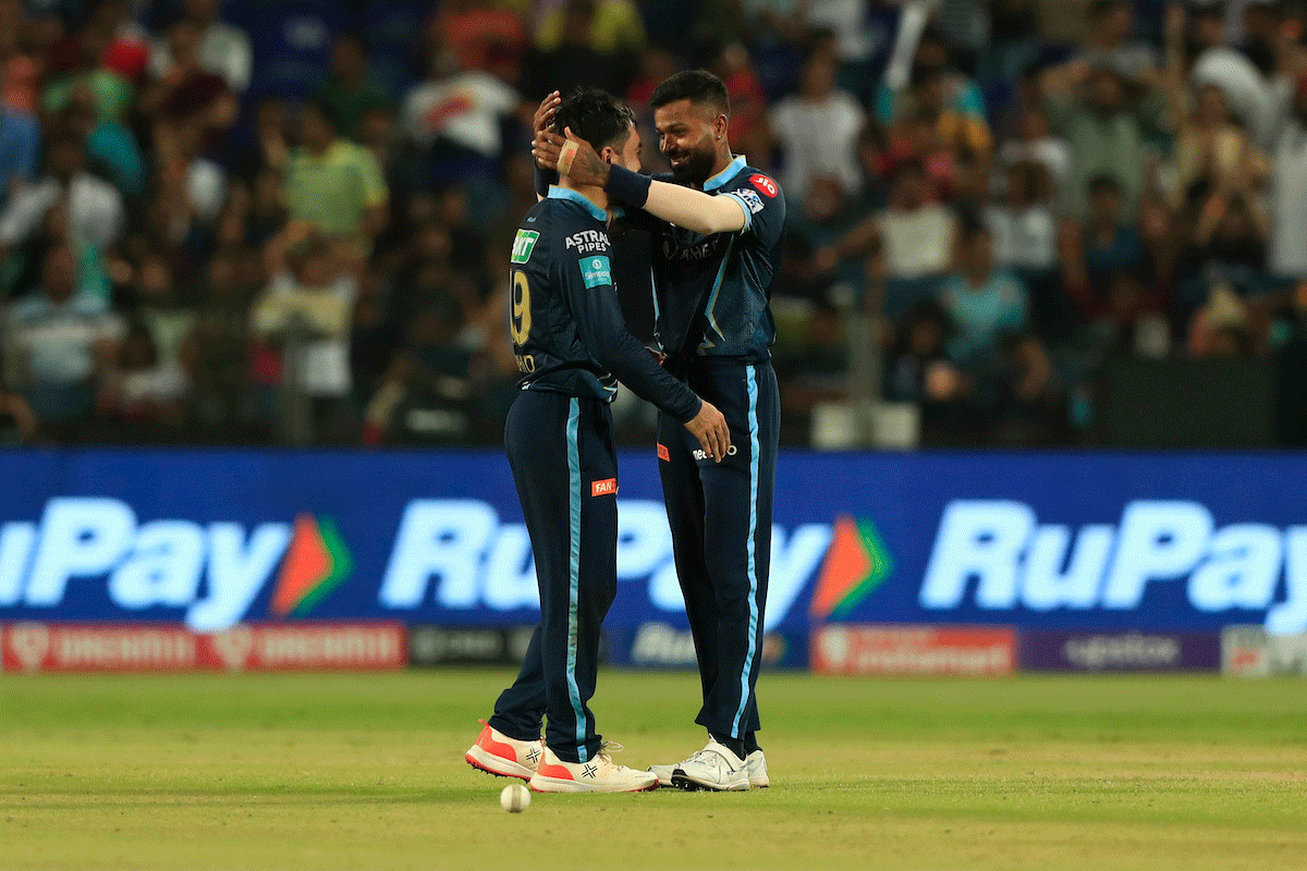 Rashid Khan and Hardik Pandya celebrate the wicket of Deepak Hooda on Tuesday