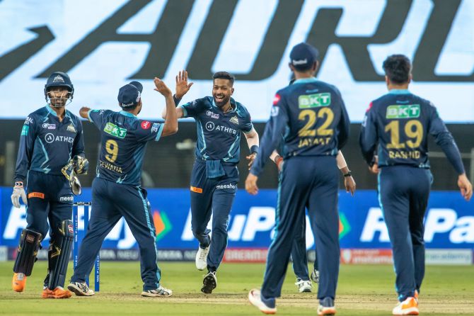 Gujarat Titans players celebrate victory over Lucknow Super Giants at the MCA International Stadium in Pune on May 10, 2022
