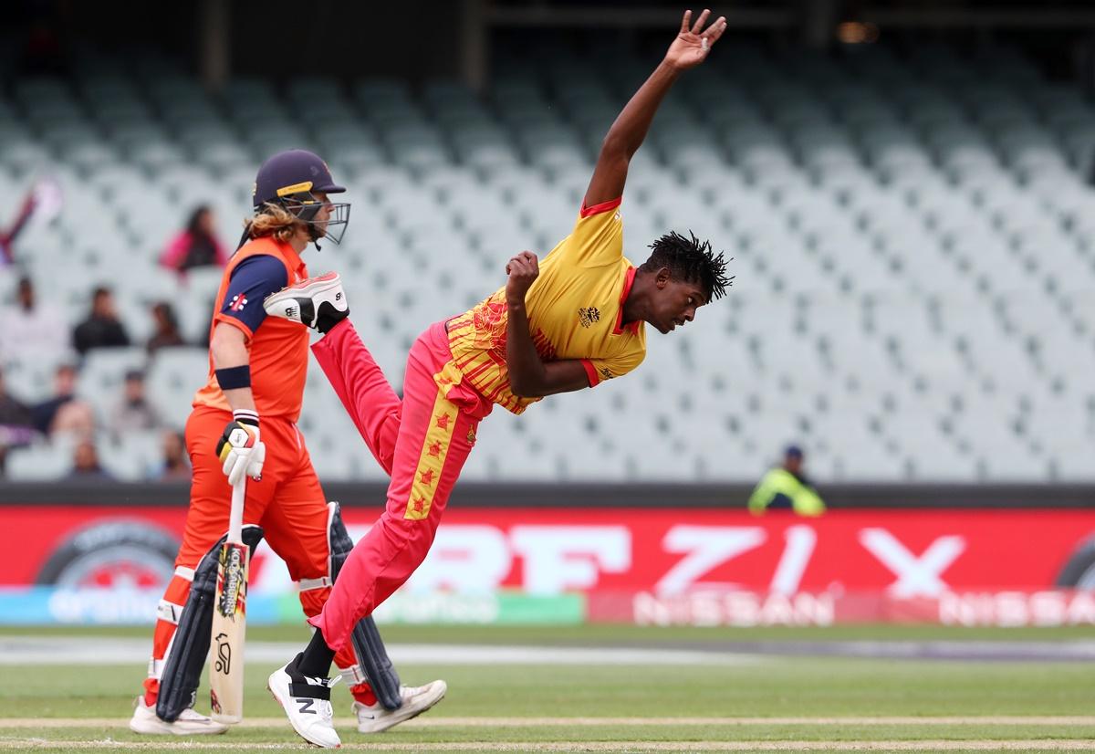 Zimbabwe's Richard Ngarava bowls as Max O'Dowd watches from the non-striker's end.