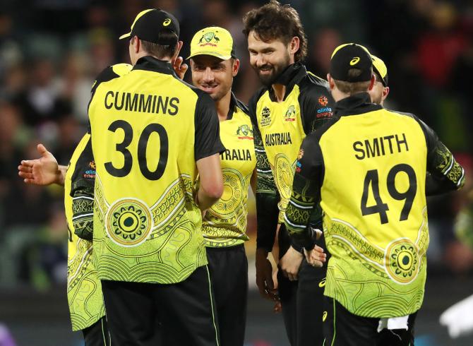  Kane Richardson celebrates with team mates after taking the wicket of Rahmanullah Gurbaz