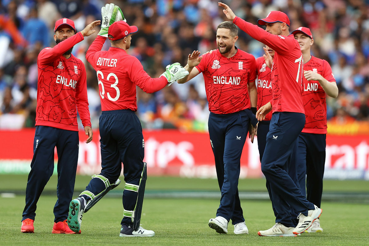 England's Chris Woakes celebrates with his team after taking the wicket of KL Rahul